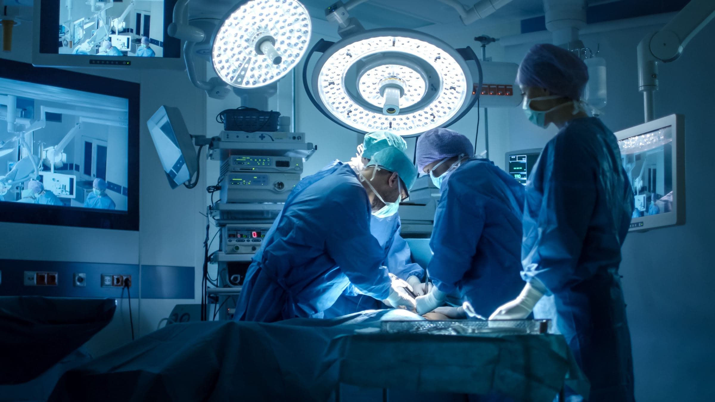 A surgical team at work under operating lights